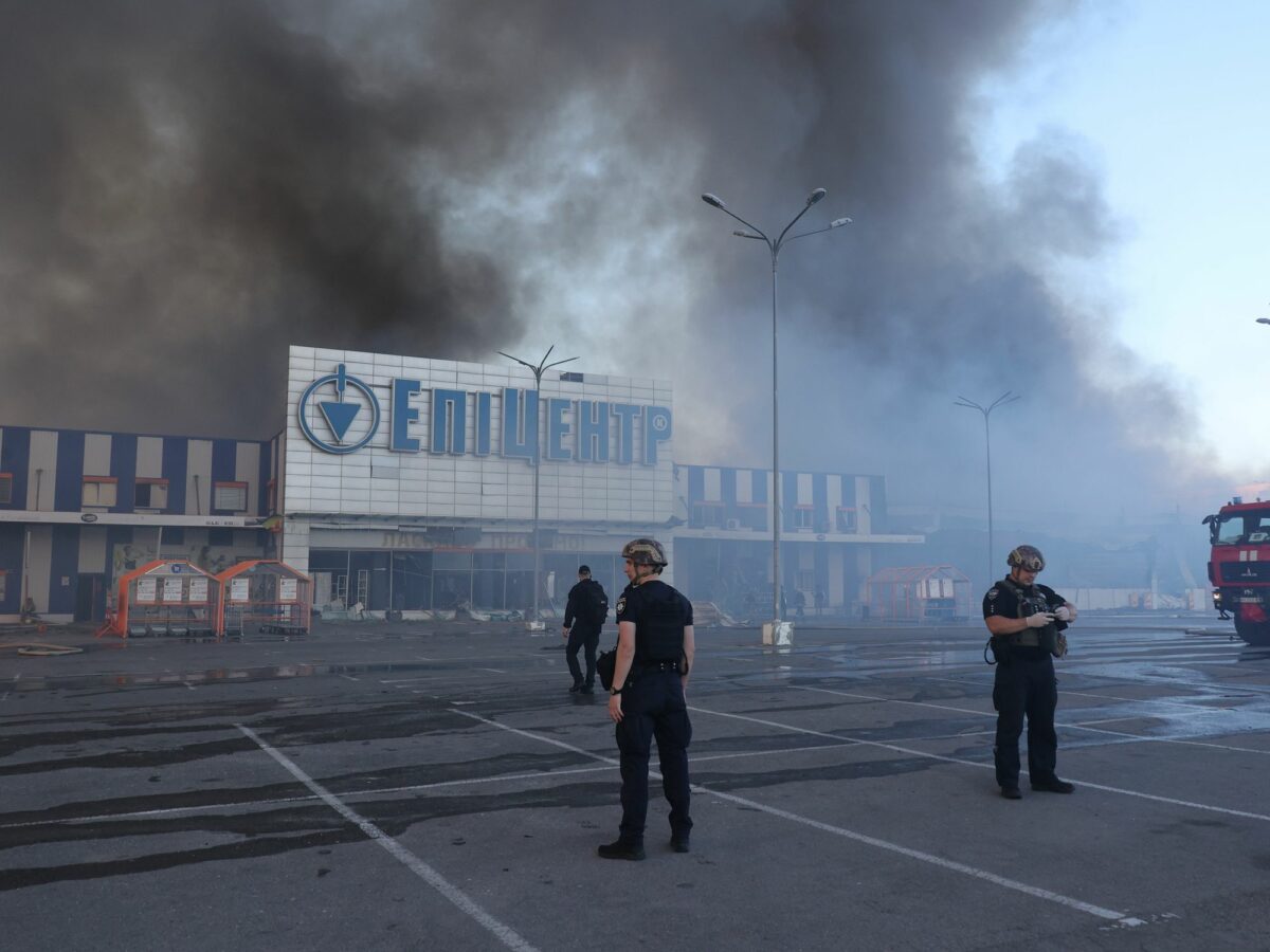 Photo of security forces standing outside a supermarket in Kharkiv after Russian airstrikes that killed at least five on May 25.
