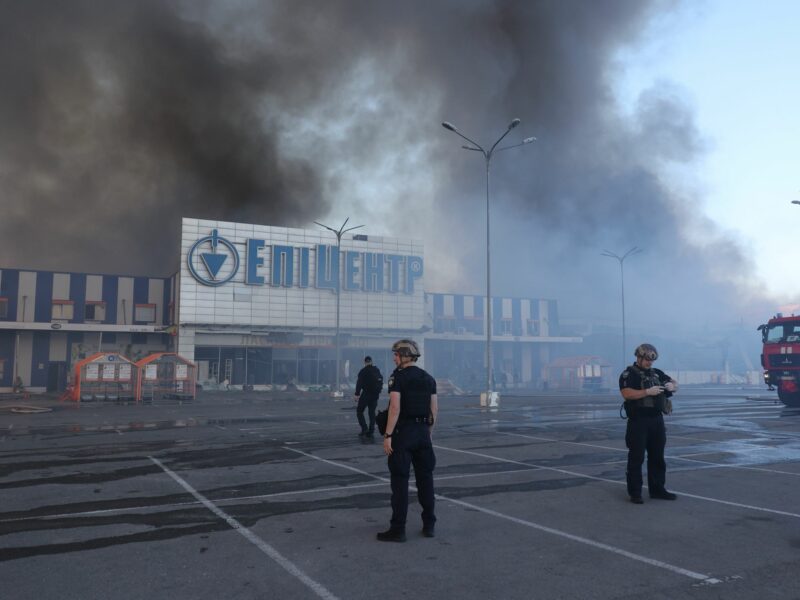 Photo of security forces standing outside a supermarket in Kharkiv after Russian airstrikes that killed at least five on May 25.