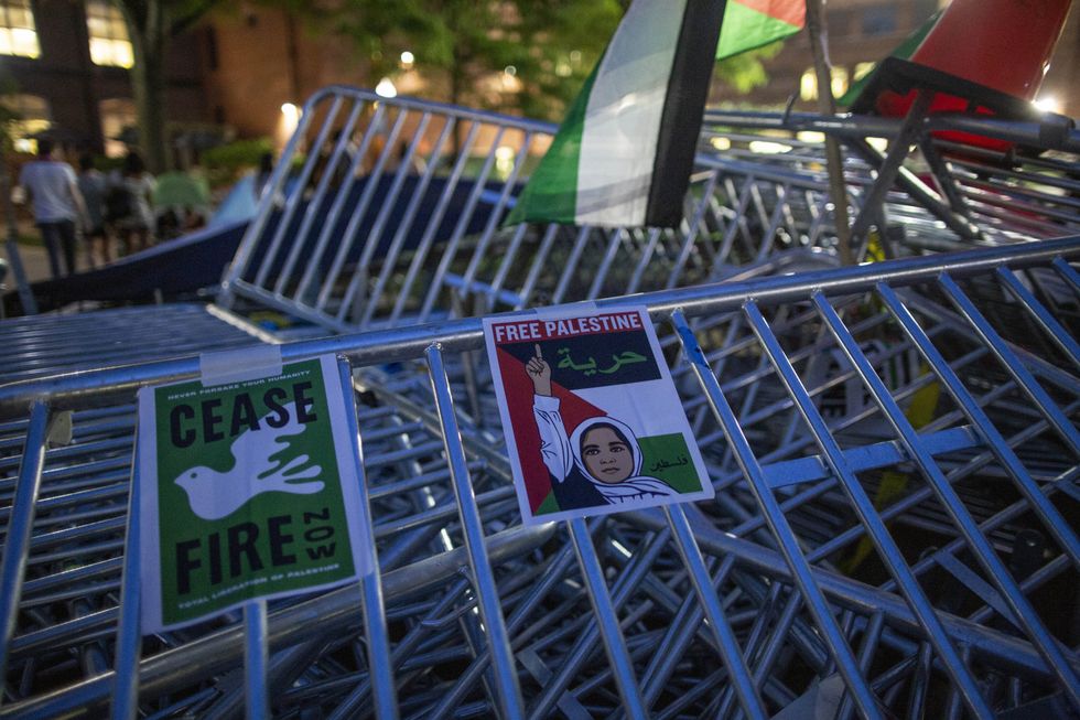 Photo of signs calling for a Gaza ceasefire stuck on barricades at a university in Washington, D.C.