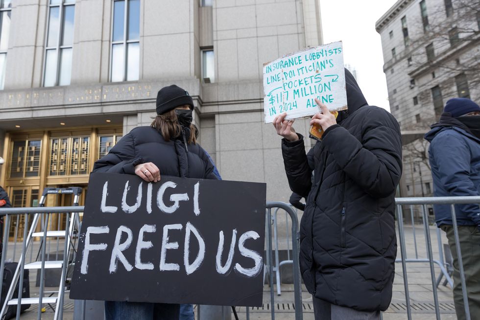 photo of signs saying luigi freed us