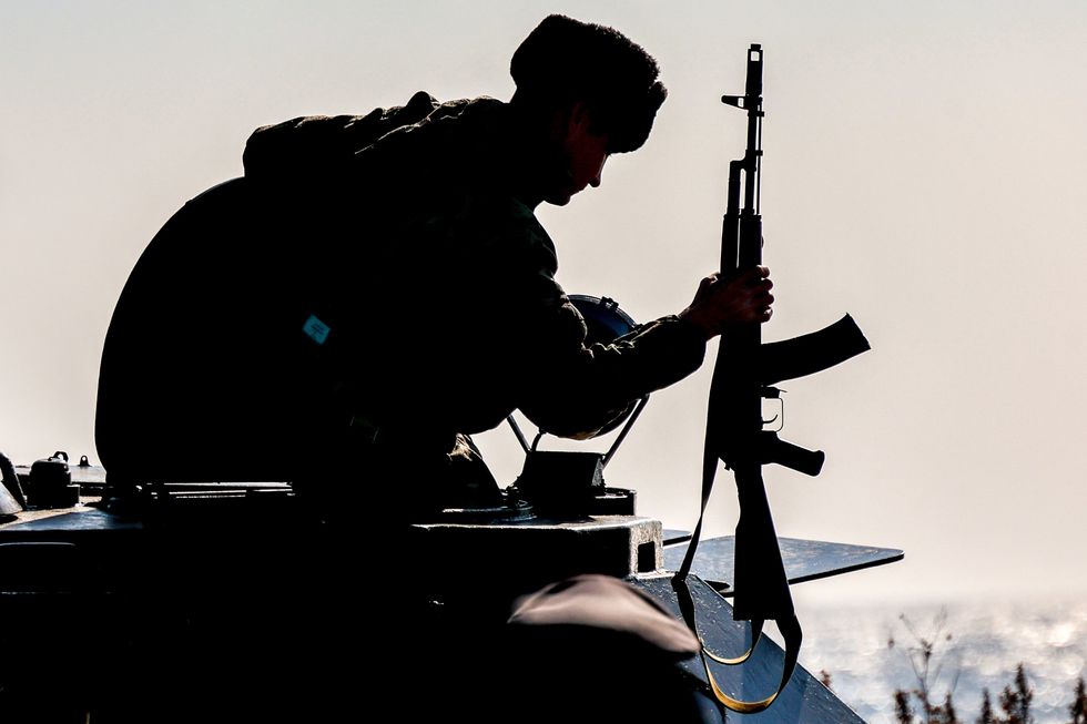 photo of silhouette of a russian soldier with an automatic rifle