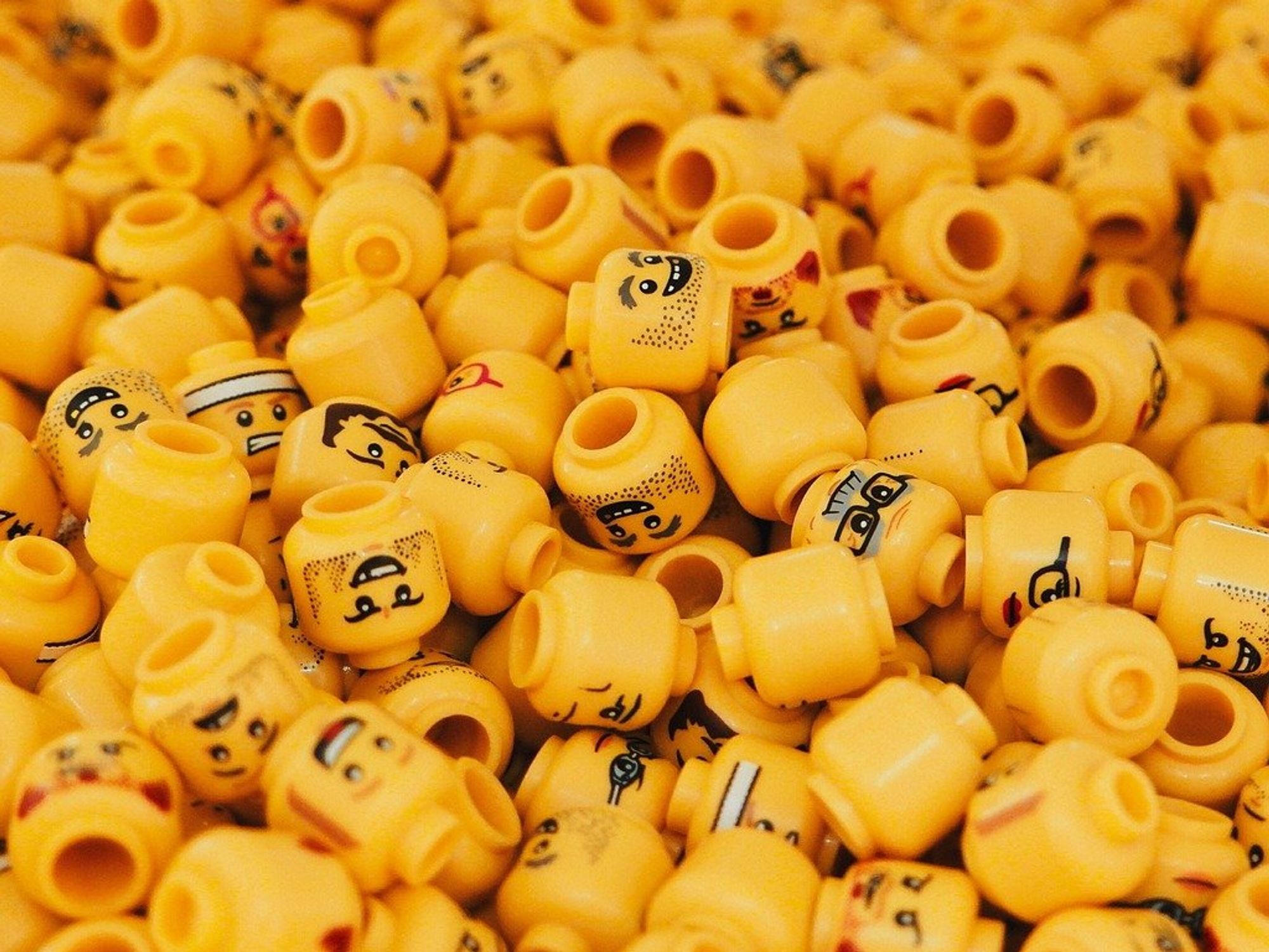 Photo of small lego heads showing all different kinds of emotions