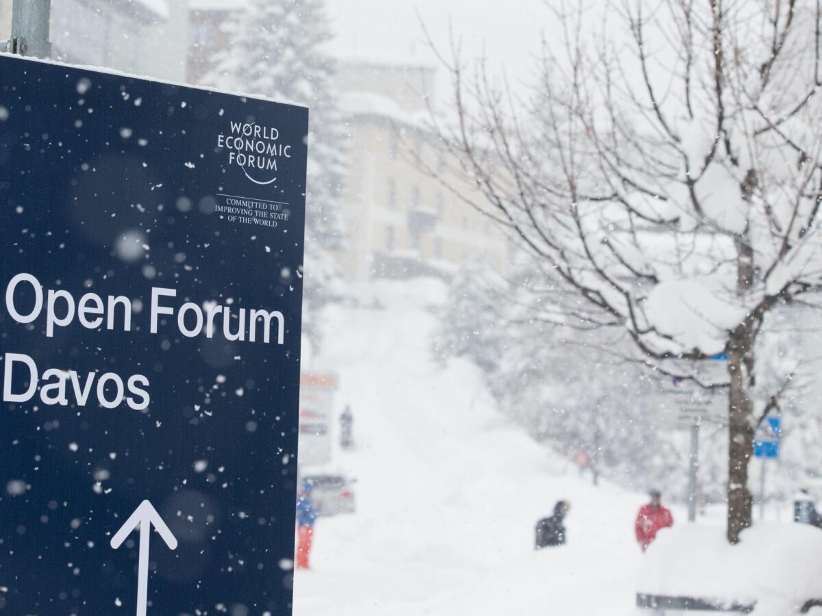 photo of snow at Davos with a sign to the Davos Forum