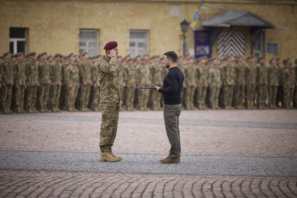photo of soldier saluting to zelensky