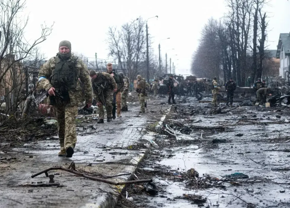 photo of soldier walking through decimated street