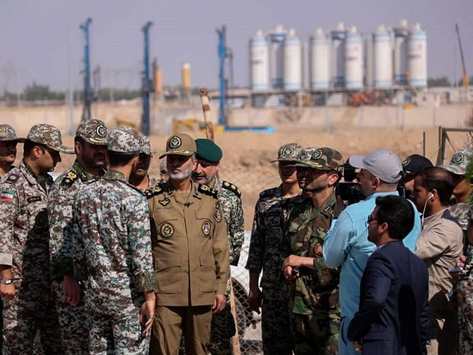 photo of soldiers and generals in front of nuclear plant