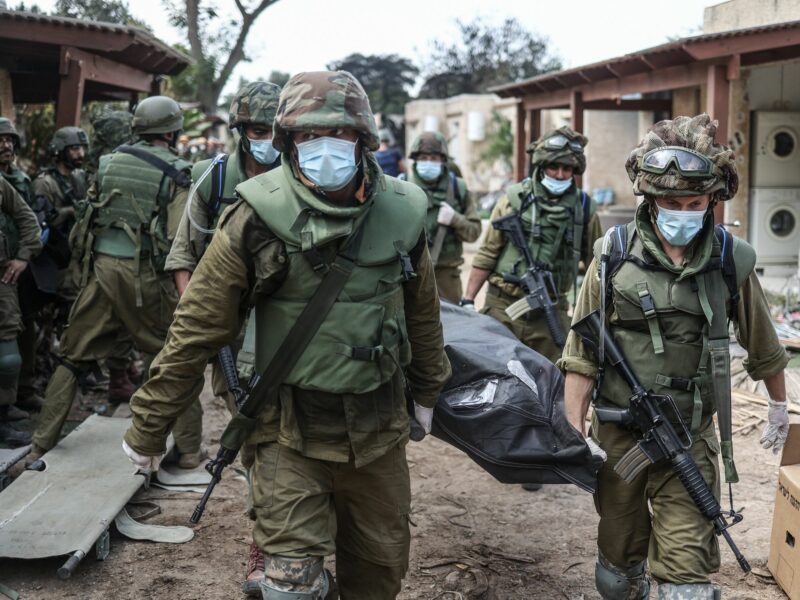 photo of soldiers with masks carrying a body bag