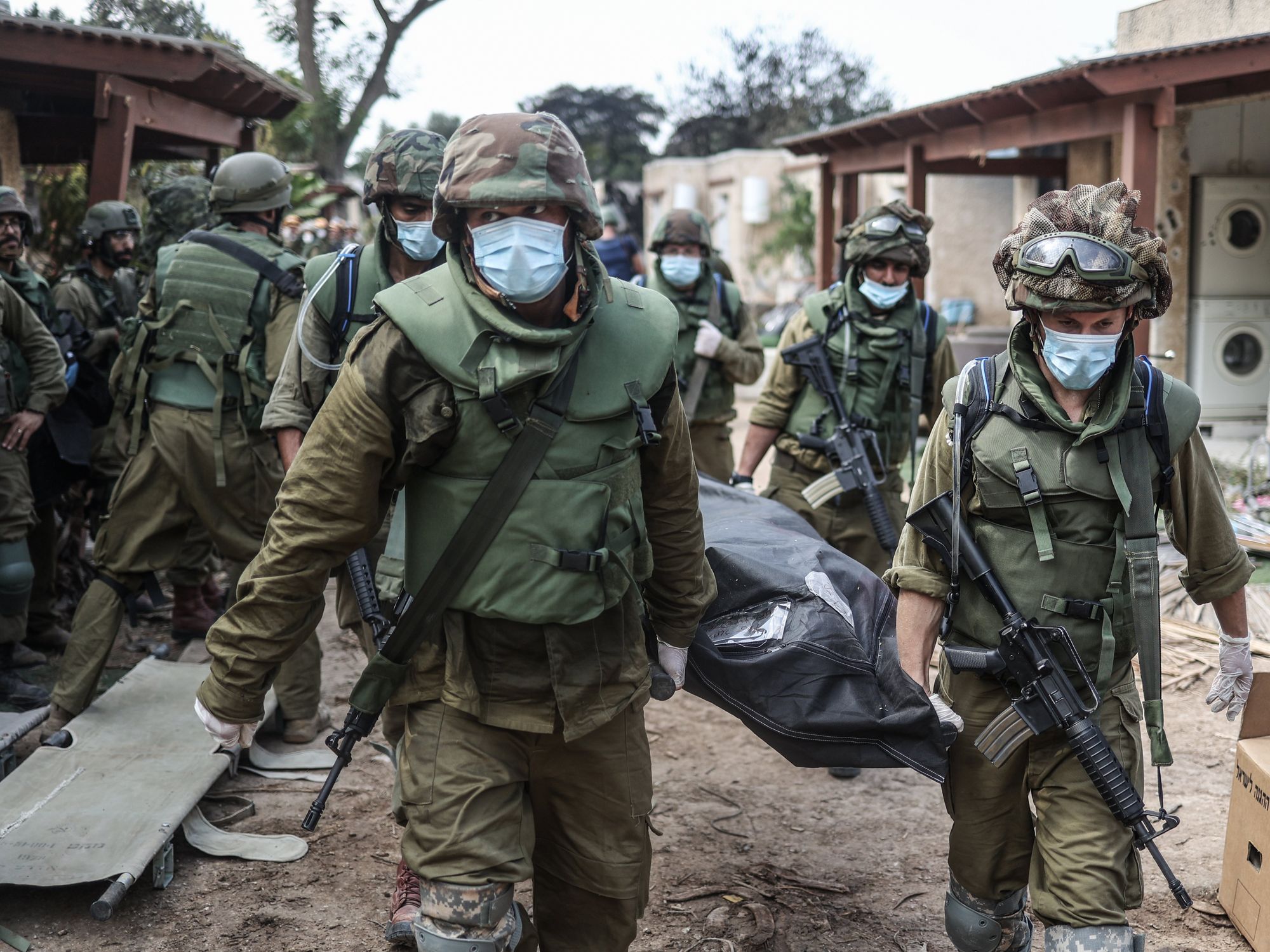 photo of soldiers with masks carrying a body bag
