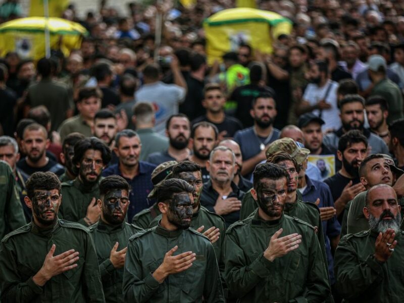 Photo of soldiers with their hands on their hearts as they attend the funeral of two Hezbollah fighters killed in an Israeli missile strike in the southern Lebanese village of Khirbet Silem on Oct. 10.
