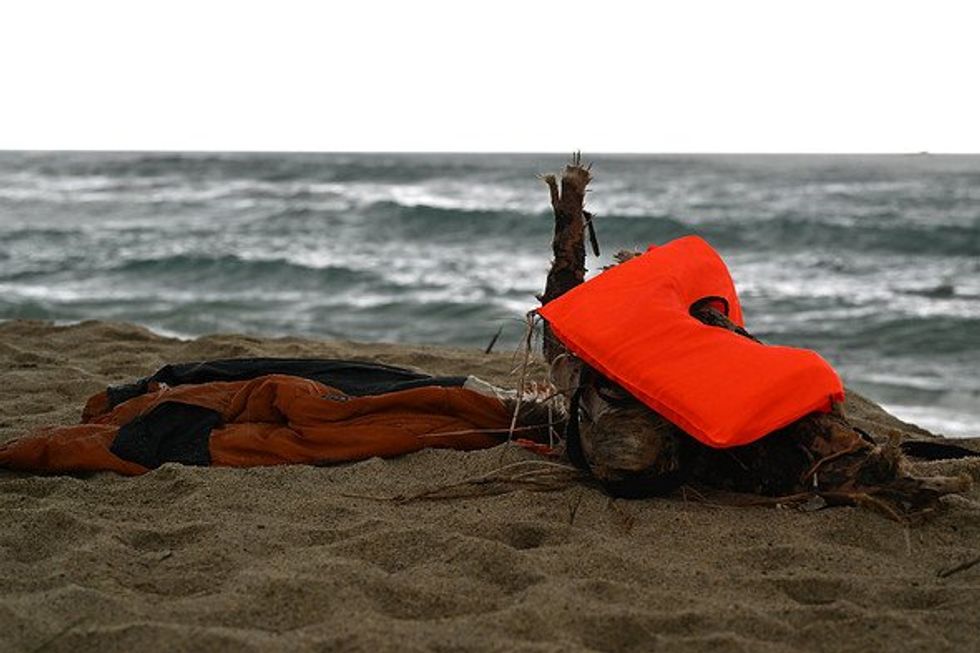 Photo of some remains of the shipwreck on the beach, including a life jacket