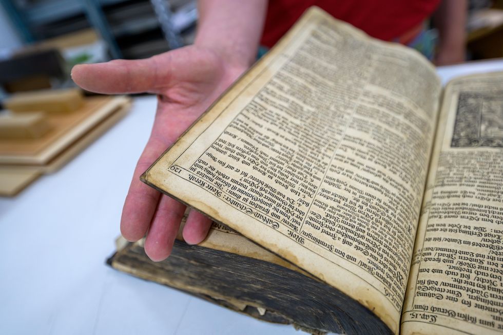 Photo of someone browsing a 200 year-old Bible