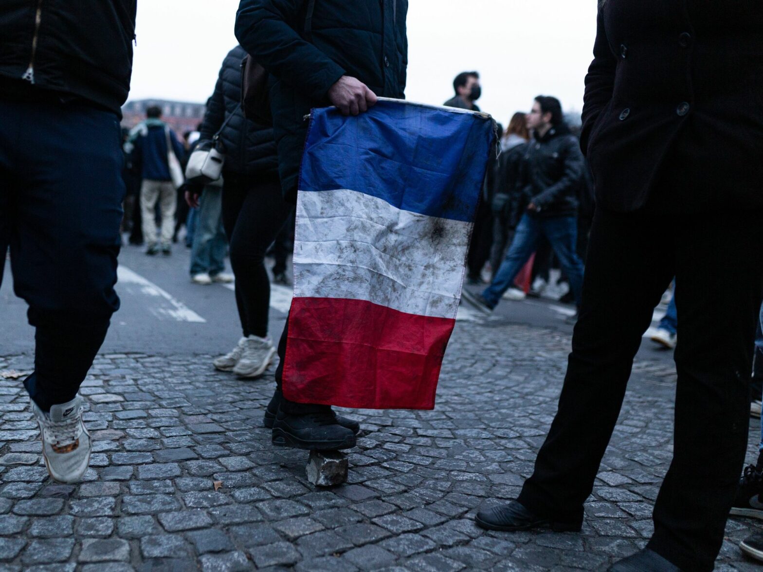 photo of someone holding a french flag