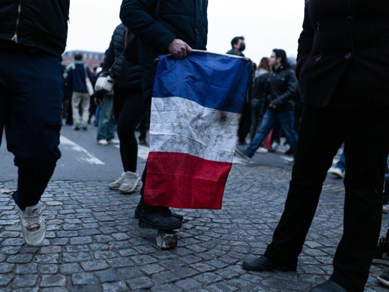 photo of someone holding a french flag