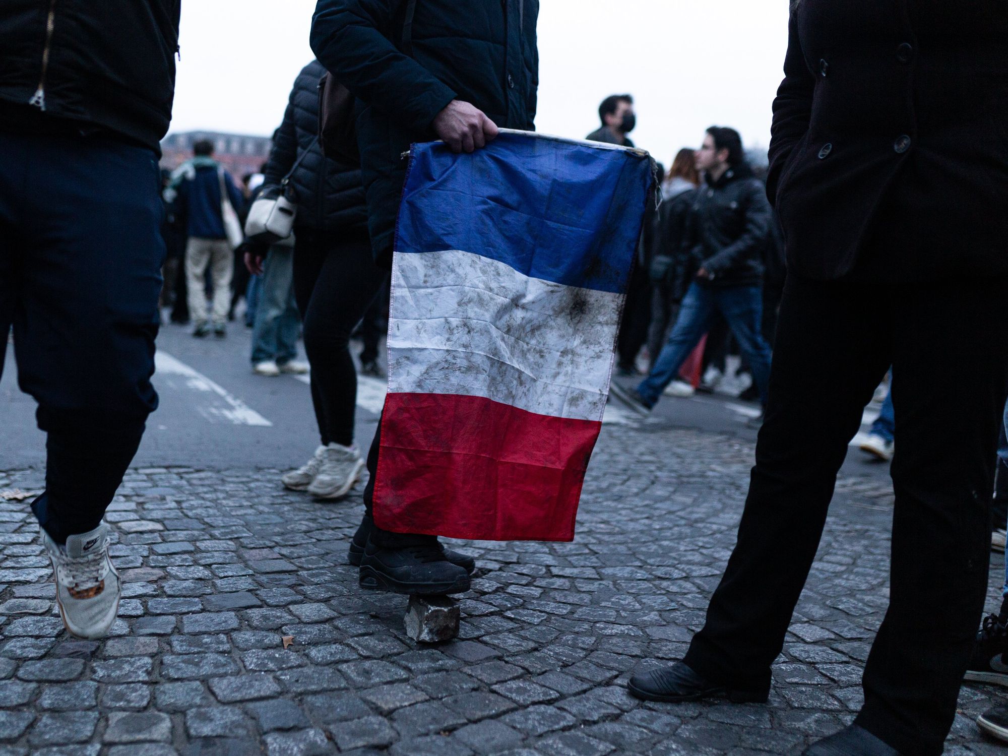 photo of someone holding a french flag