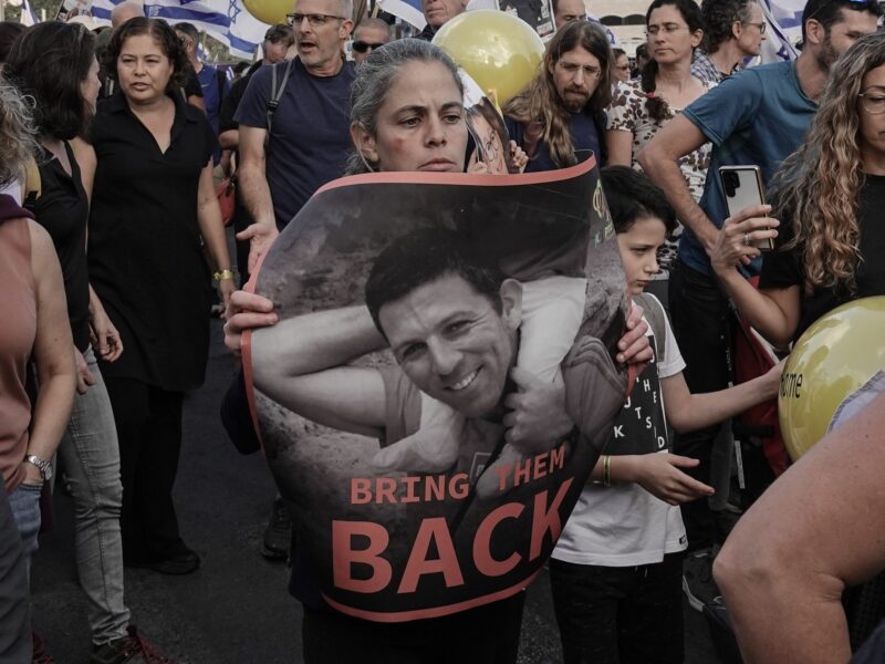 photo of someone holding a poster of a hostage