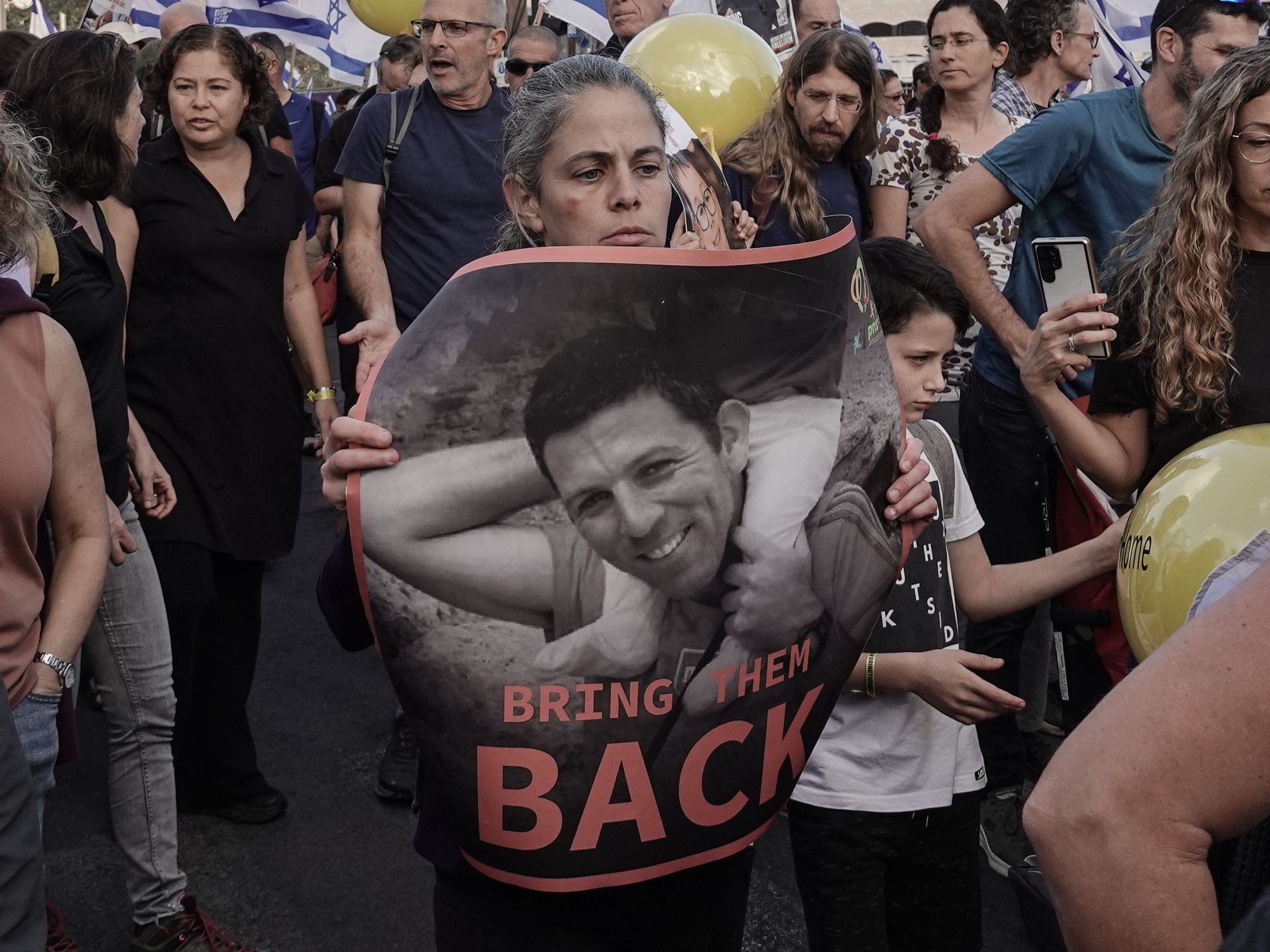 photo of someone holding a poster of a hostage