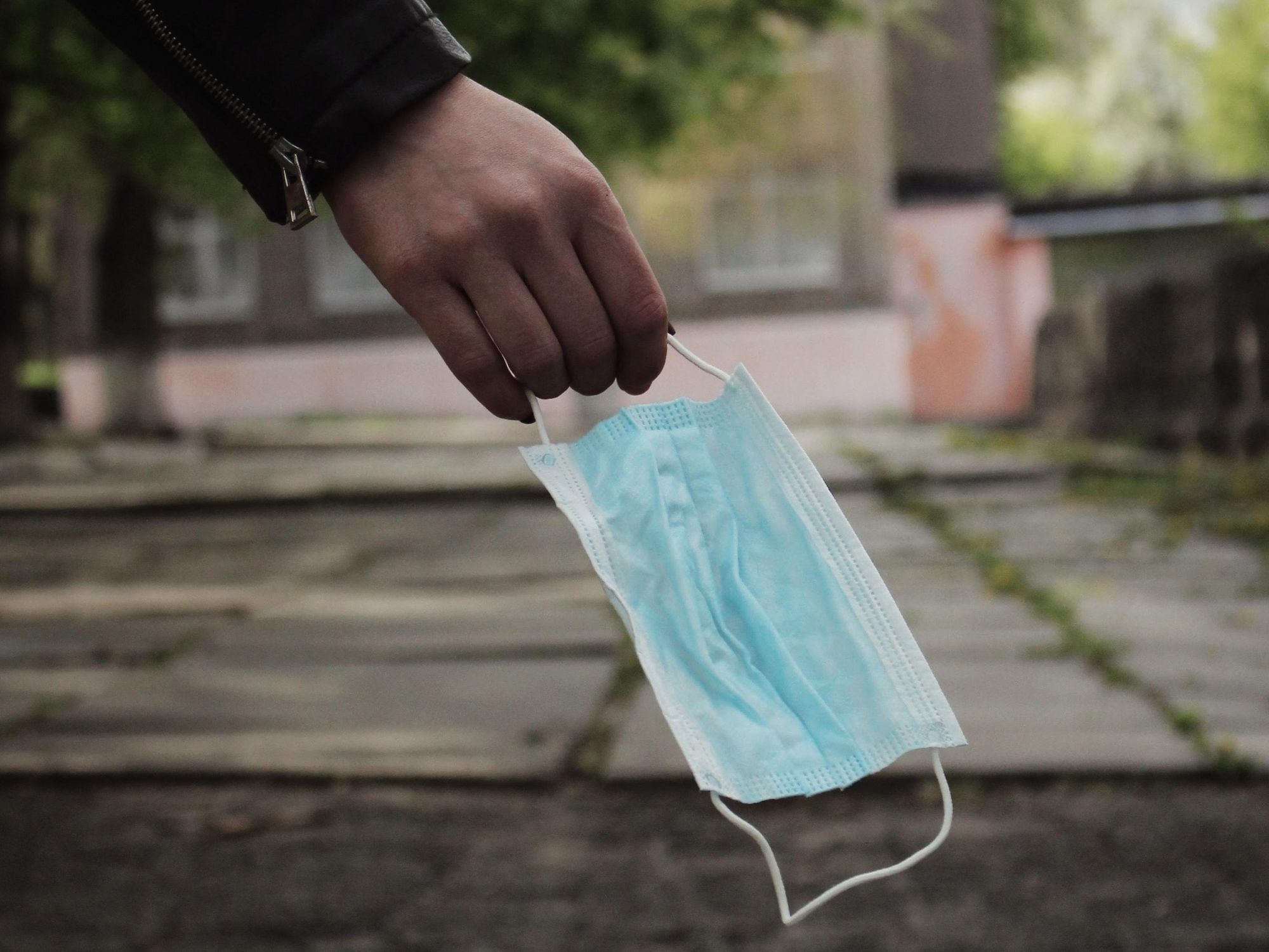 Photo of someone holding a surgical mask