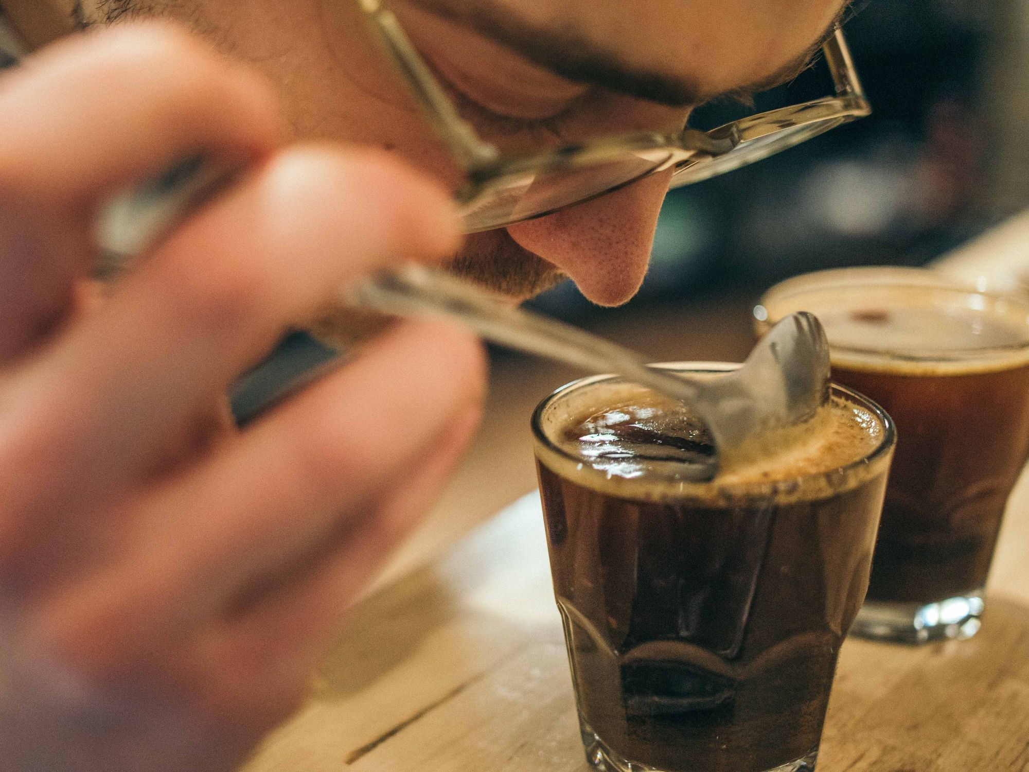 Photo of someone smelling a cup of coffee
