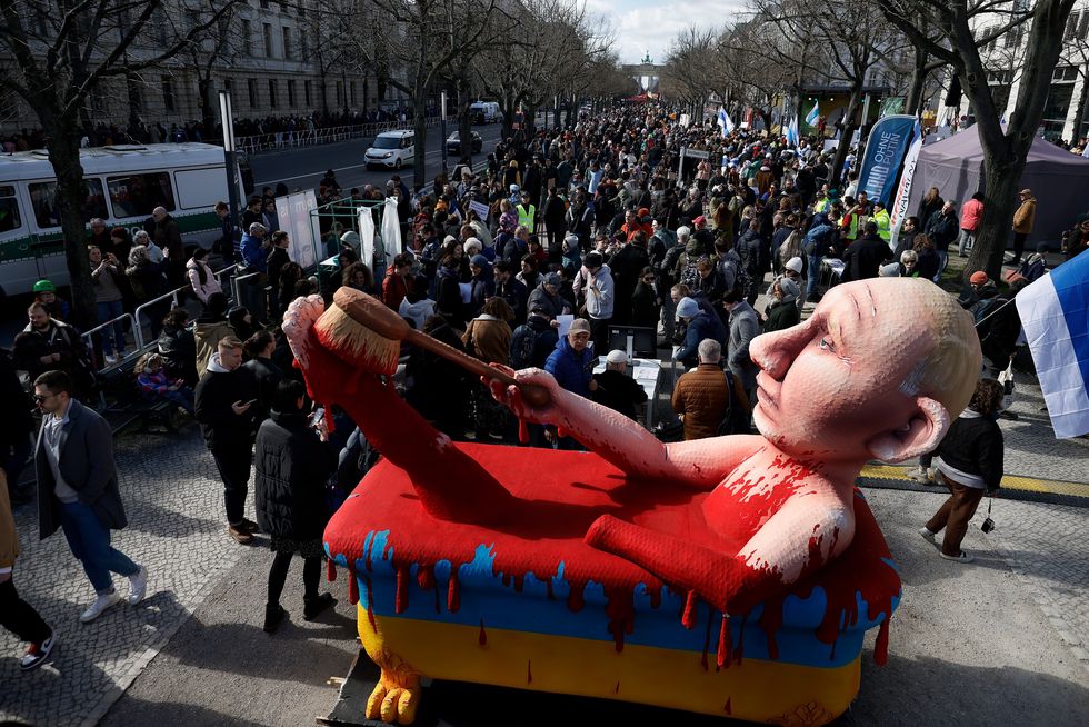photo of statue of putin taking a bath in blood