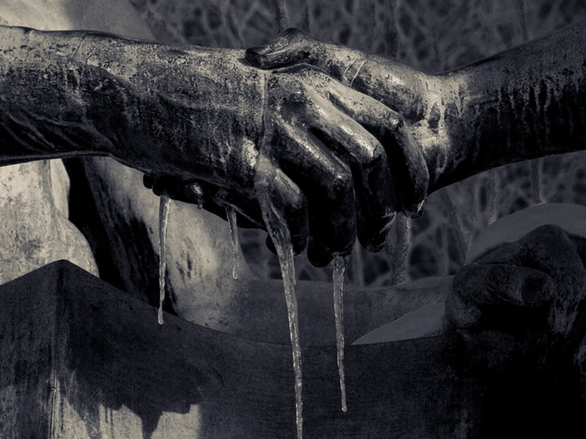 Photo of statues exchanging a frozen handshake