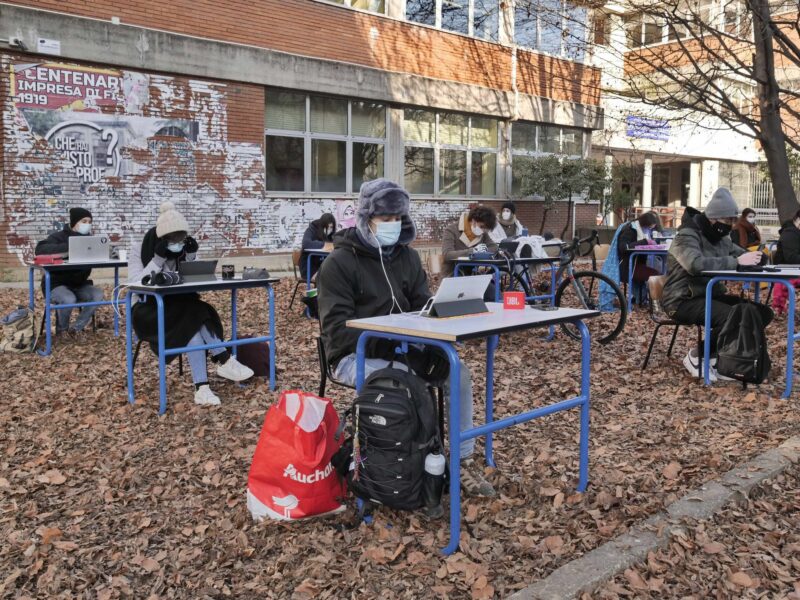 photo of students at desks outside in bergamo italy