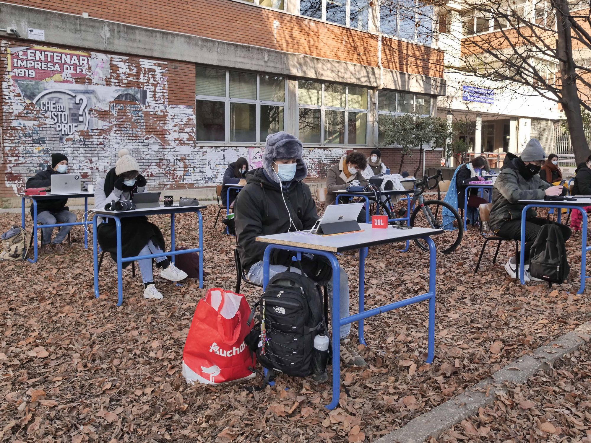 photo of students at desks outside in bergamo italy