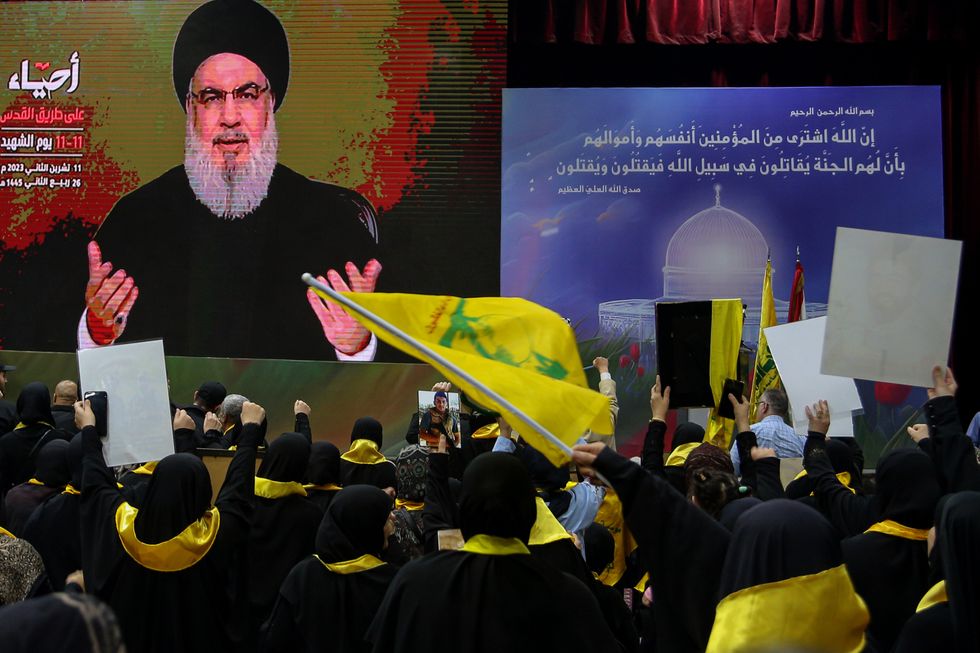 Photo of supporters of the Lebanese Shiite Muslim movement Hezbollah, watch the movement's chief Hassan Nasrallah deliver an address on a large screen to mark the Martyrs' Day