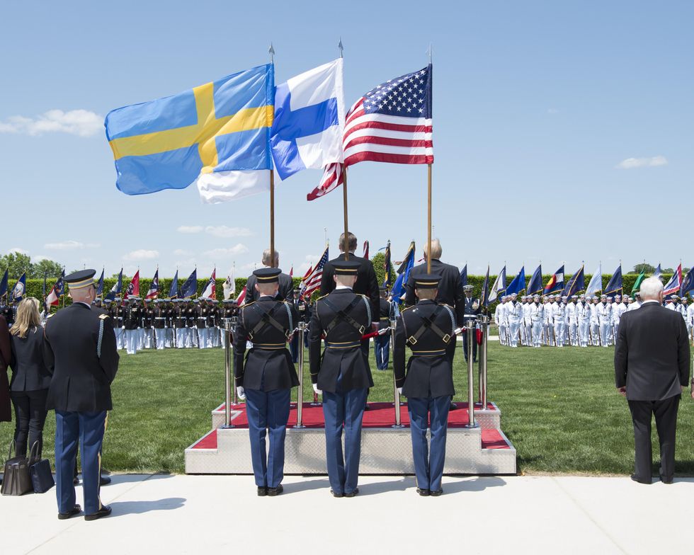 photo of swedish, finnish and american flags at military ceremony