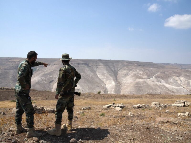 Photo of Syrian soldiers looking at ground zero, a triangle of Syrian territory slicing between Jordan and the Israeli-occupied Golan Heights.