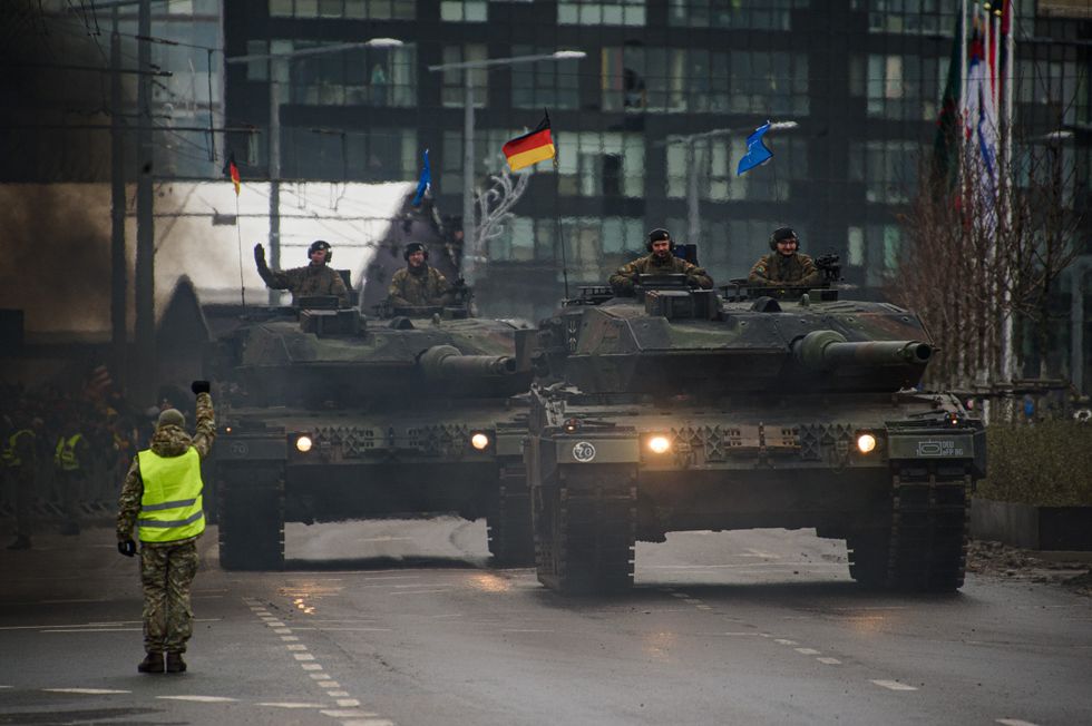 photo of tanks on a street in a parade