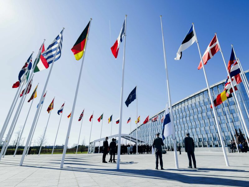 Photo of the flag of Finland being hoisted in front of NATO's headquarters in Brussels