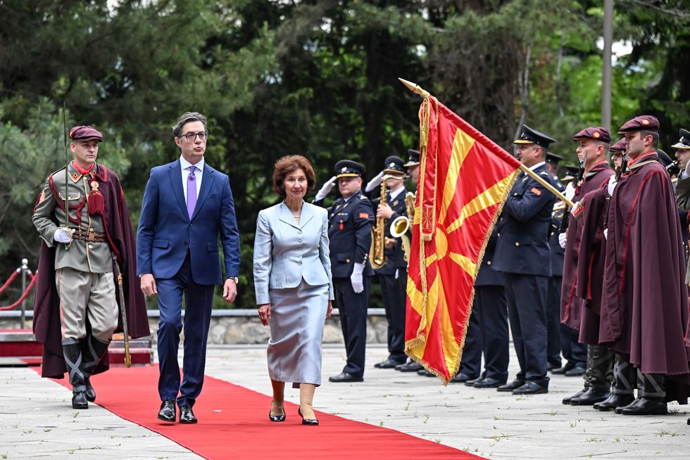 Photo of the new North Macedonian President, Gordana Siljanovksa walking alongside outgoing President Stevo Pendarovski as they review troops in Skopje, North Macedonia, on May 12, 2024.