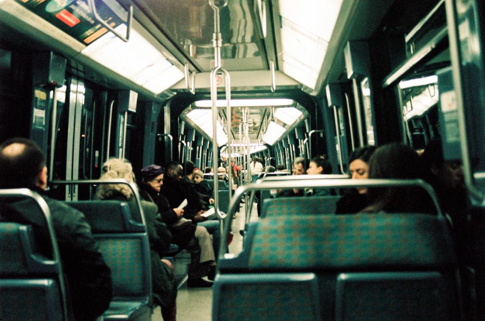 Photo of the parisian metro with people sitting