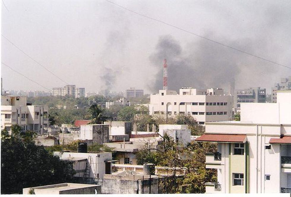 Photo of the skyline in Ahmedabad during the 2002 Gujarat riots, with smoke from explosions