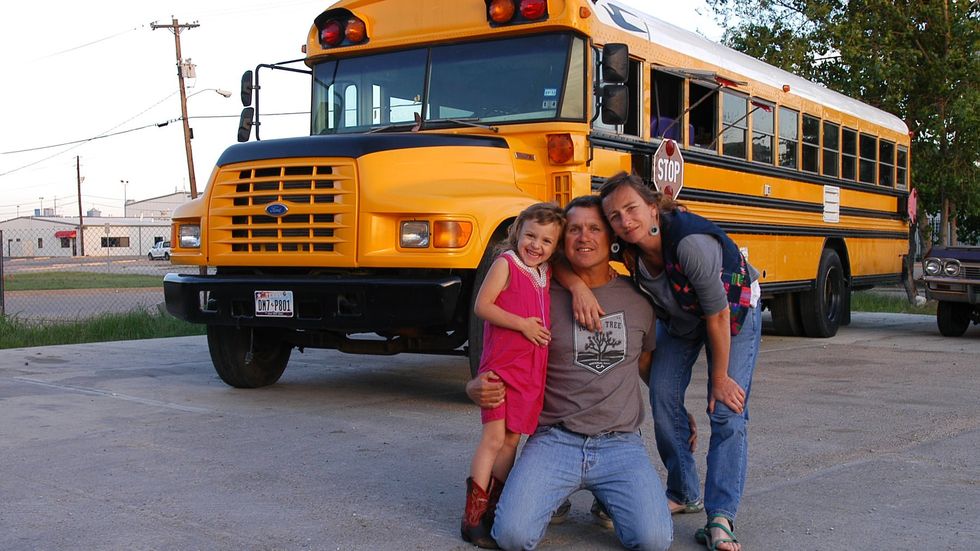 Photo of the van-loving family in front of their converted schoolbus in Dallas, in 2012