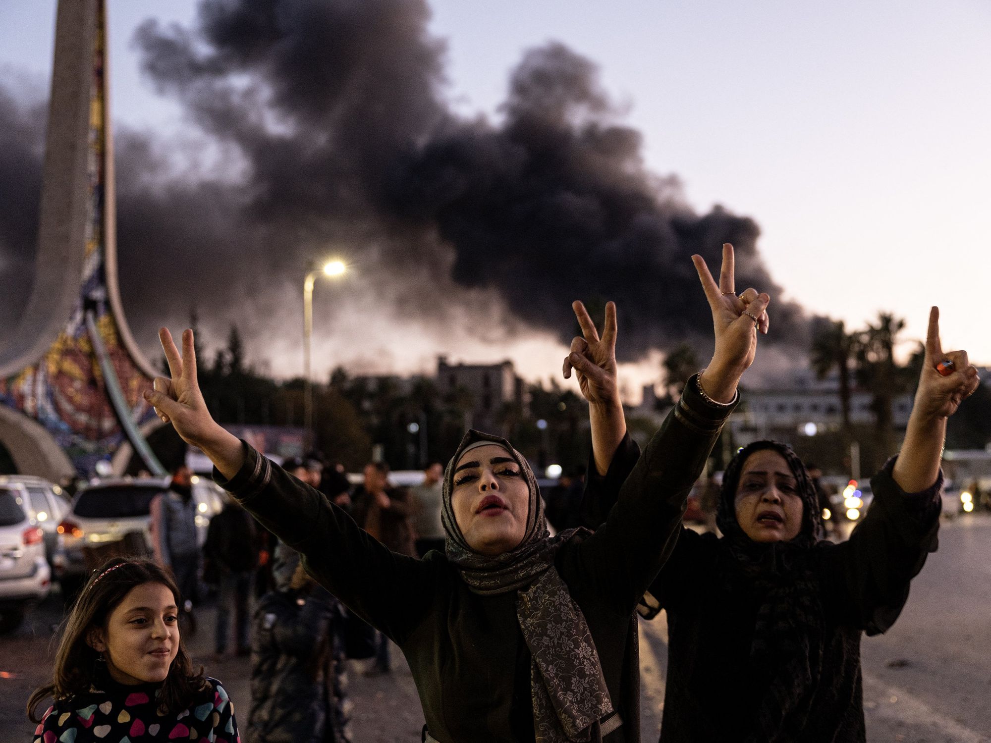 Photo of three generations of women celebrating after Assad's fall