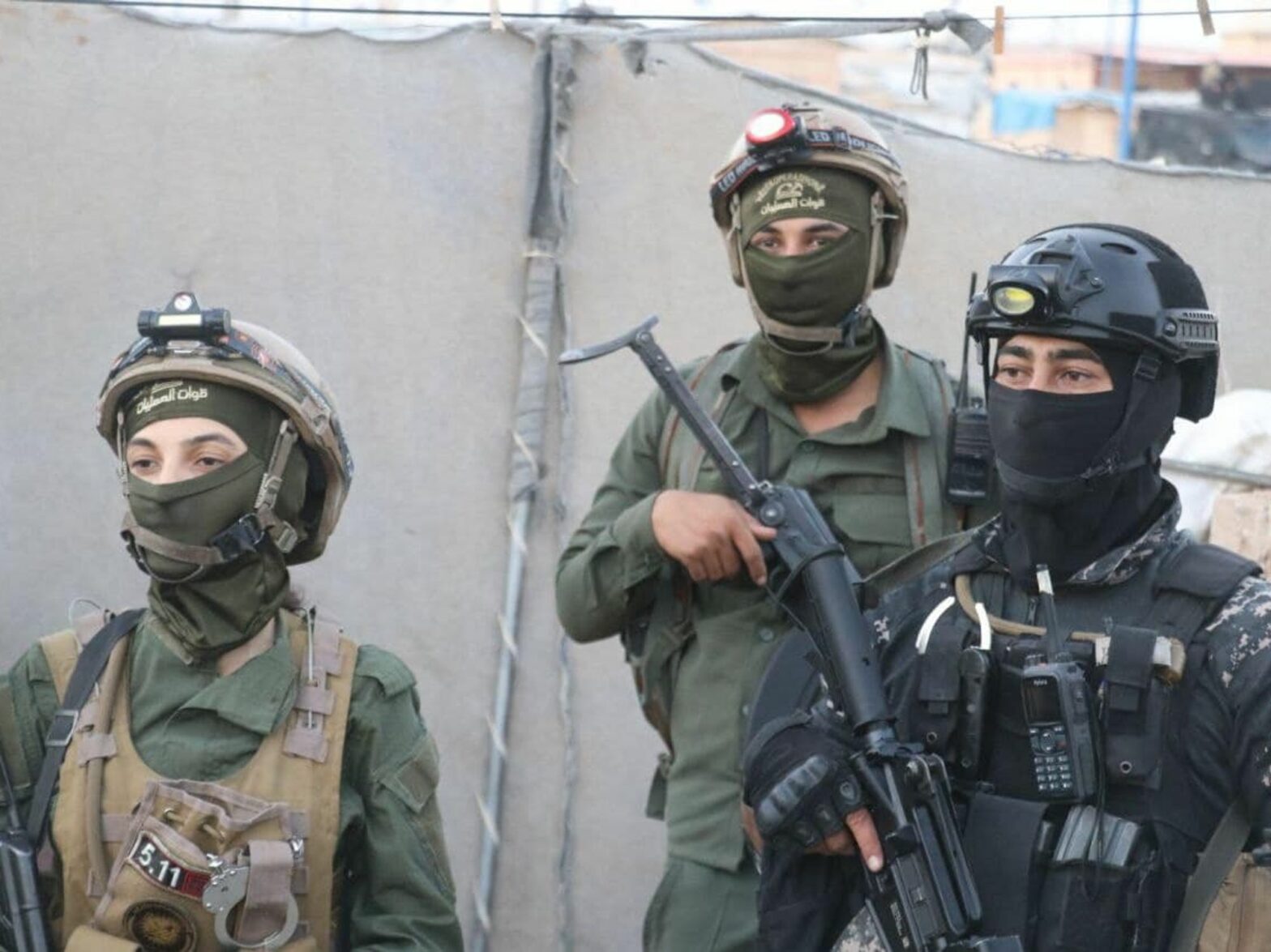 photo of three soldiers with automatic rifles
