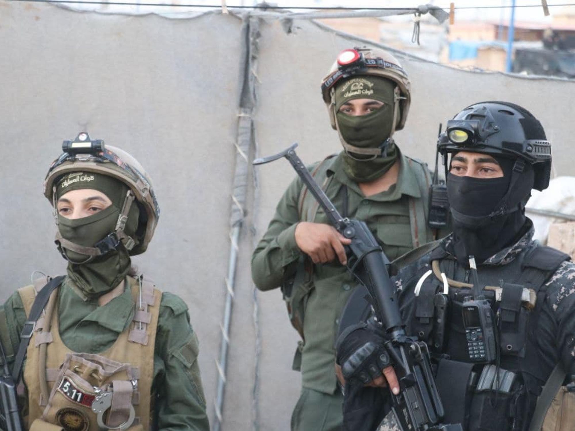 photo of three soldiers with automatic rifles