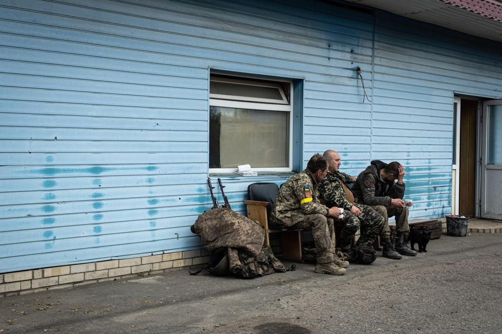 Photo of three Ukrainian soldiers resting at a checkpoint on the outskirt of the separatist region of Donetsk.