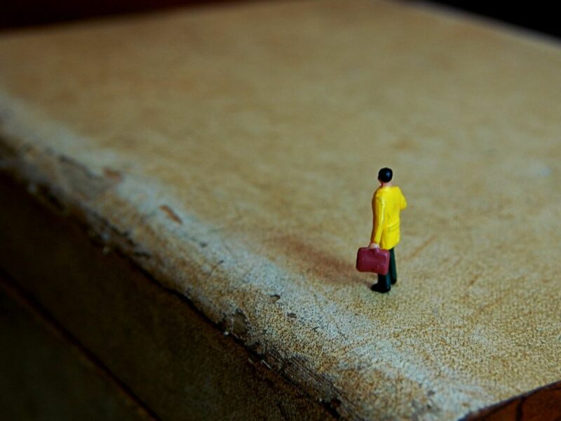 photo of tiny figure on an old suitcase