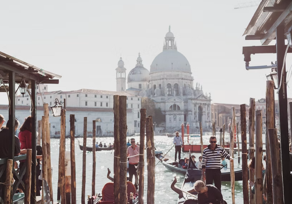 Photo of tourists on gondolas in Venice, Italy