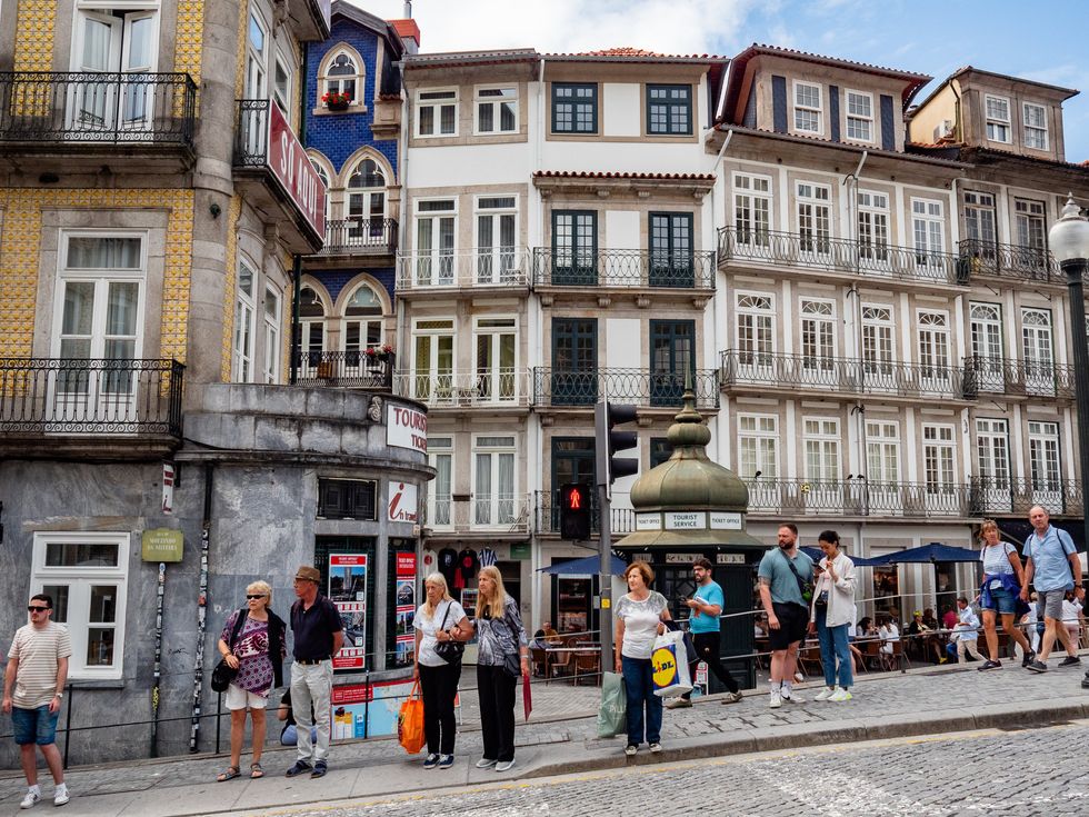 Photo of tourists waiting to cross the street in Porto.