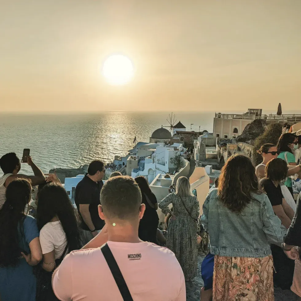 Photo of tourists who come together to take photographs of the Santorini sunset