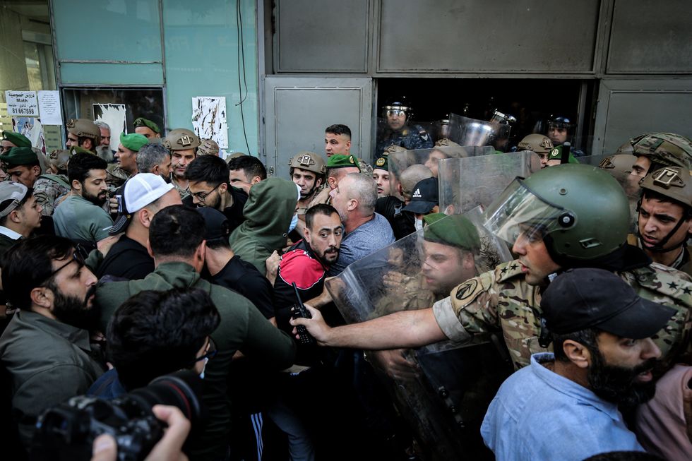 photo of troops scuffling with residents