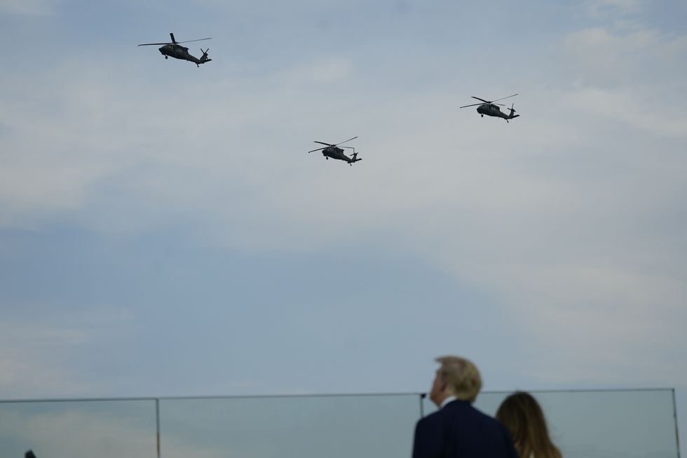 photo of trump couple with helicopters above.