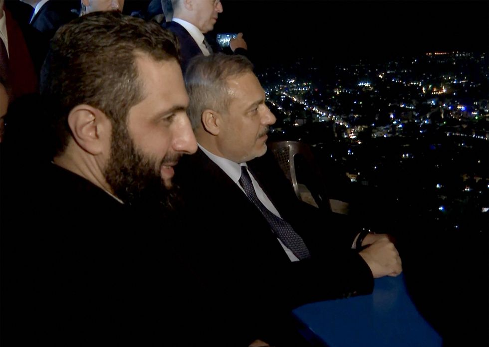 Photo of Turkish Foreign Minister Hakan Fidan and and Ahmed al-Sharaa in Damascus on December 22.