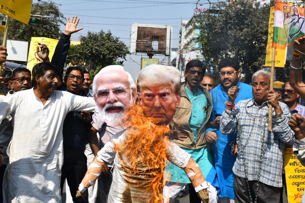 Photo of two burning images of Donald Trump and Narendra Modi.