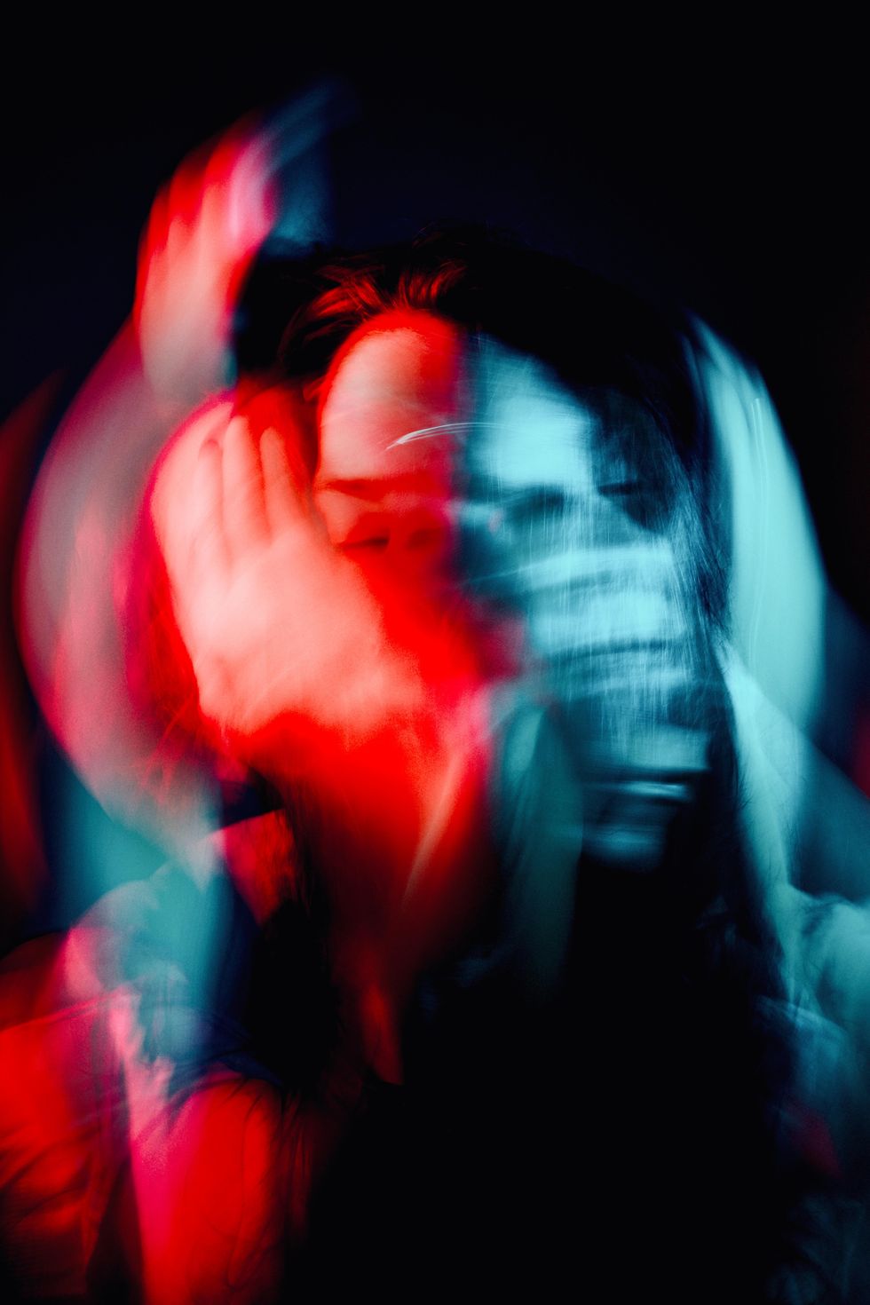 Photo of two faces merged together with red and blue lights