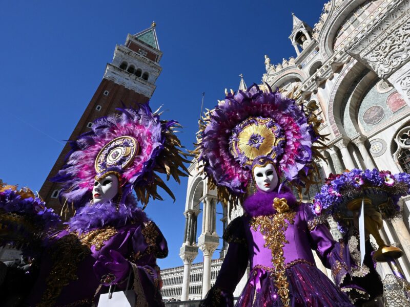 Photo of two masked Carnival revelers in Venice, Italy