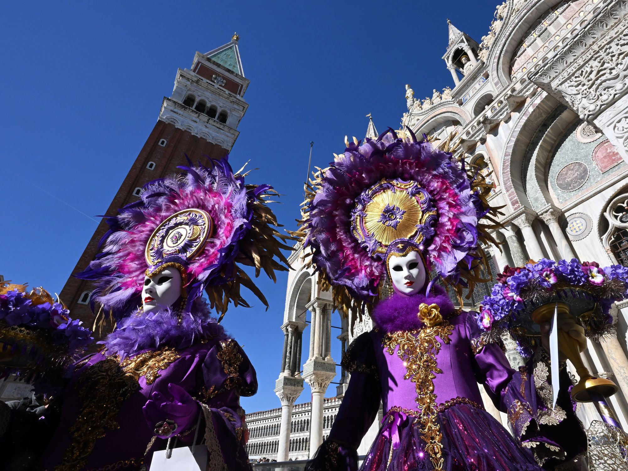 Photo of two masked Carnival revelers in Venice, Italy